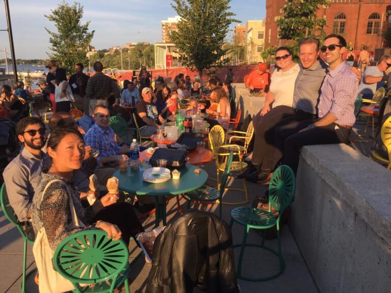 Residents sit outside in the sun on terrace