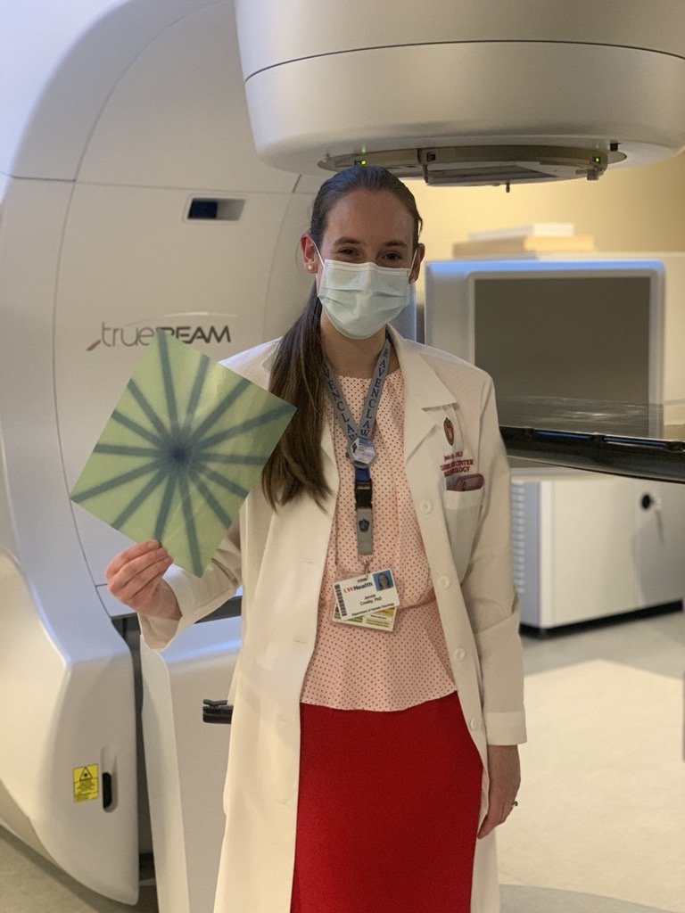 Dr. Crosby holds film near TrueBeam
