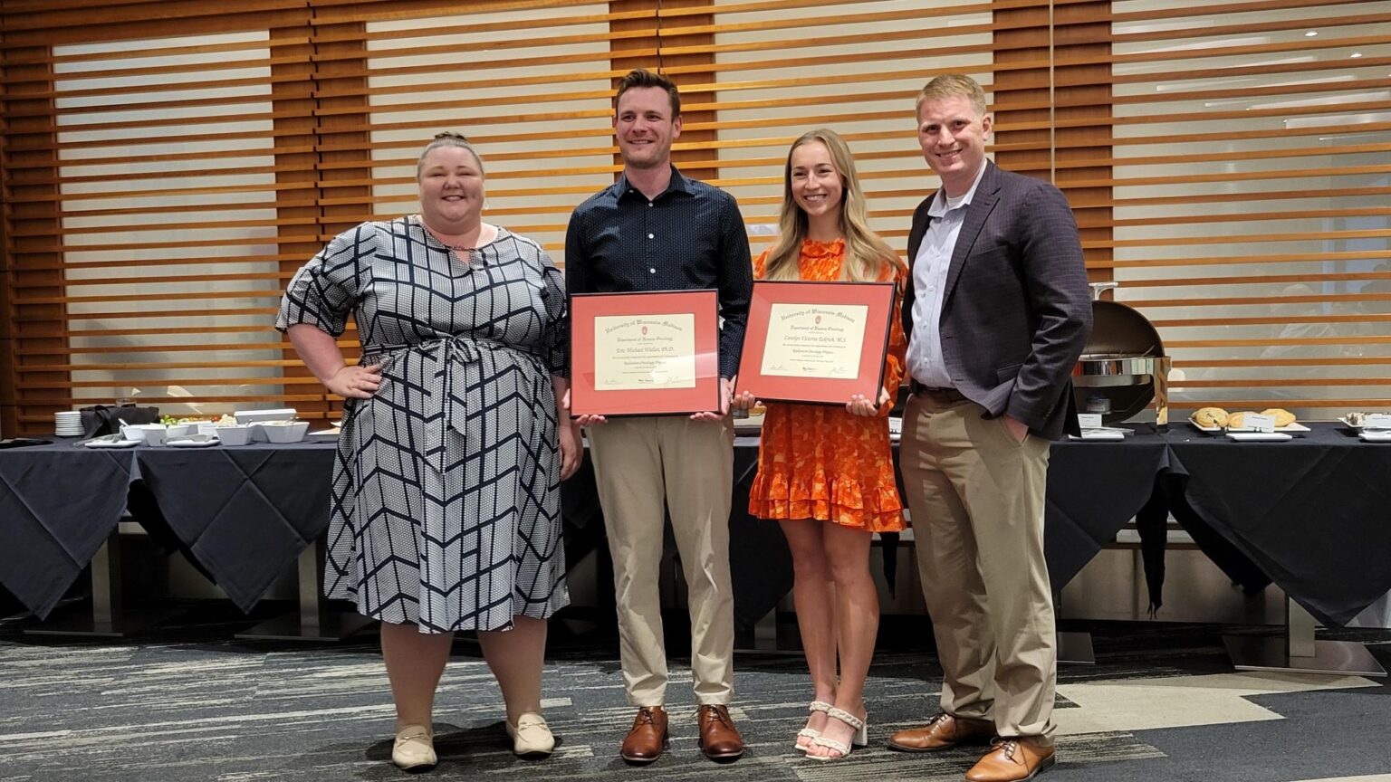 Abby, Zach, Eric and Carolyn smile with certificates