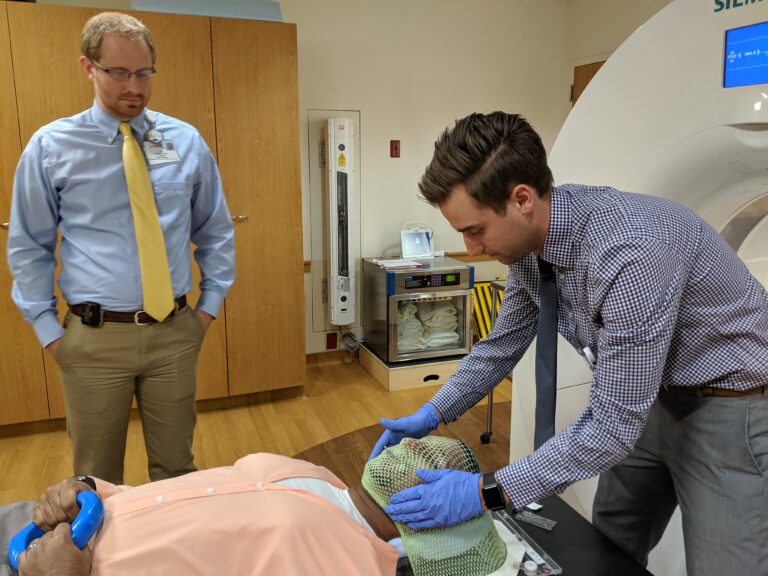 Dr. Shepard fits a patient's mask