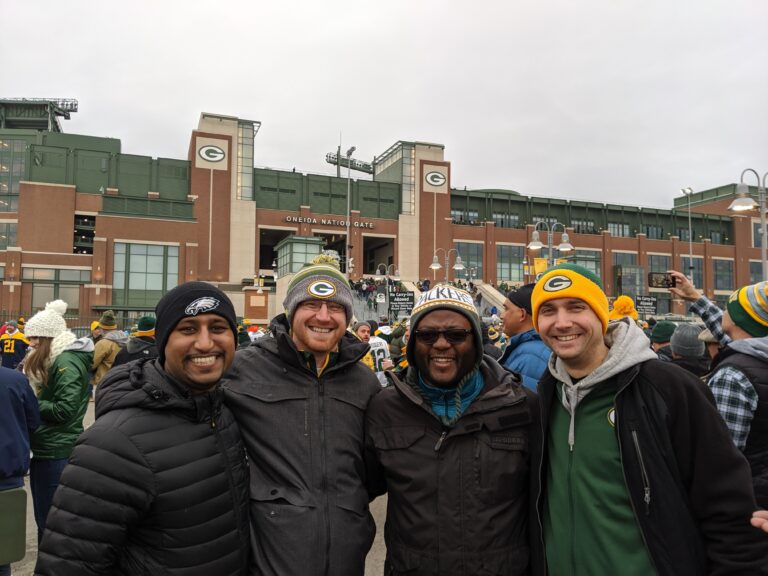 Group of four people at a green bay packers game