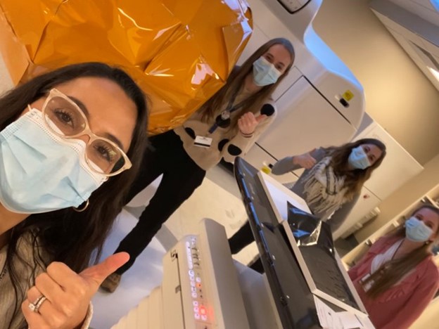 Four masked residents give a thumbs up